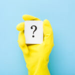 Cleaner,Hand,In,Yellow,Rubber,Protective,Glove,Showing,White,Card