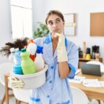 Young,Blonde,Woman,Wearing,Cleaner,Uniform,Holding,Cleaning,Products,With