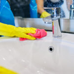 Cleaning,The,Bathroom.,Close,Up,Of,Hands,In,Gloves,With