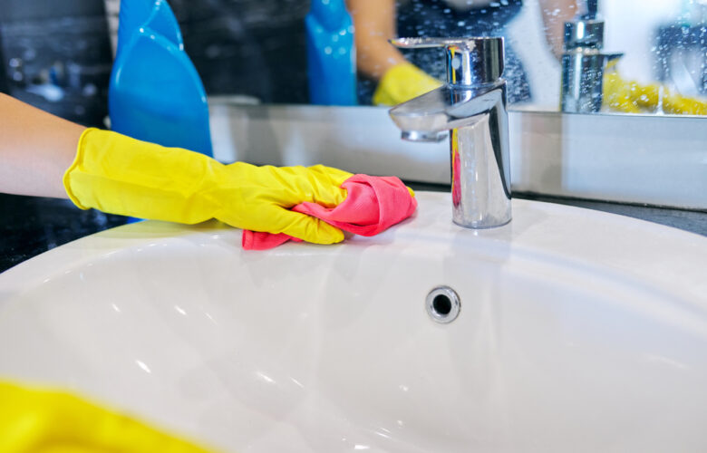 Cleaning,The,Bathroom.,Close,Up,Of,Hands,In,Gloves,With