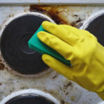 Hand,In,Glove,Washing,Messy,Kitchen,Stove